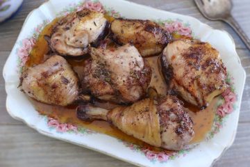 Baked chicken with red wine on a platter