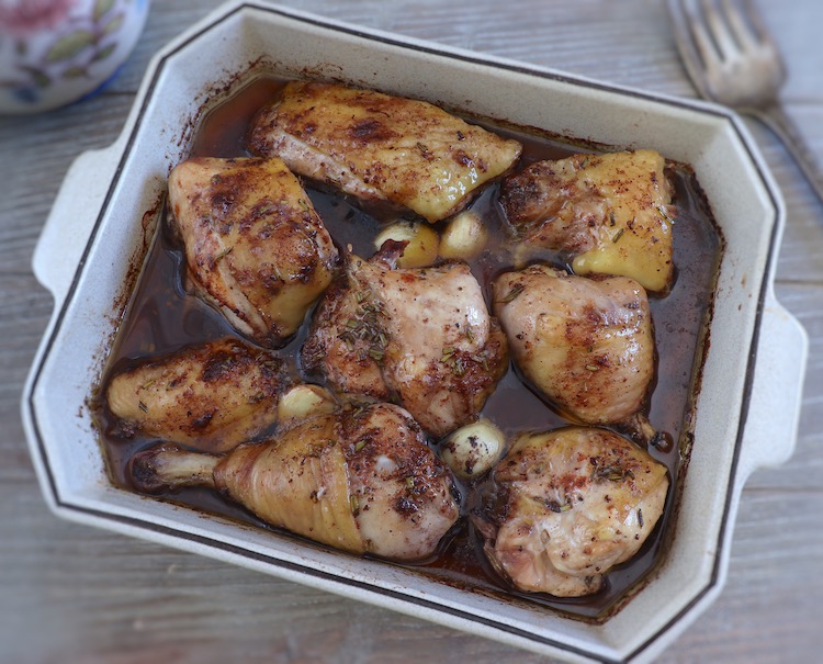 Baked chicken with red wine on a baking dish