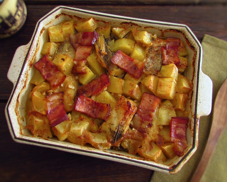 Cod in the oven with bacon and honey on a baking dish