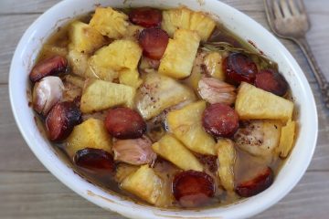 Baked chicken with chouriço and pineapple on a baking dish