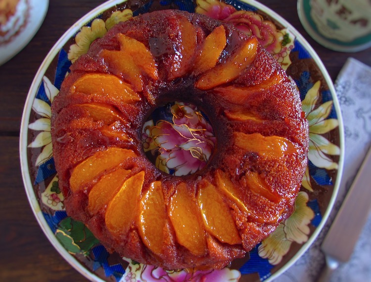 Coffee cake with caramelized peach on a plate