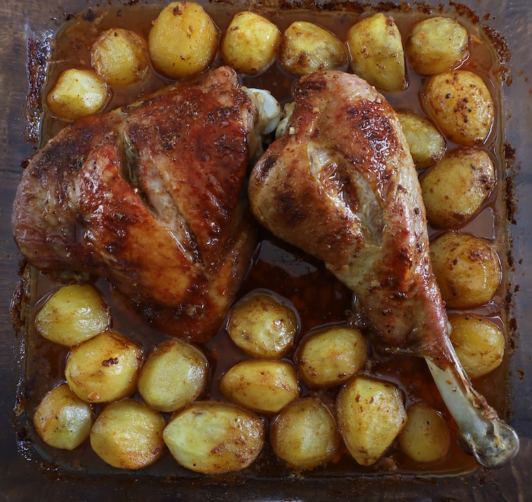 Roasted turkey leg with honey and spices on a glass baking dish