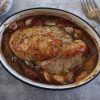 Baked turkey loin with apple and garlic on a baking dish