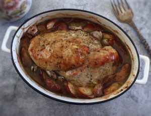 Baked turkey loin with apple and garlic on a baking dish
