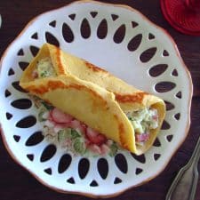 Crepes filled with cod and bacon on a plate