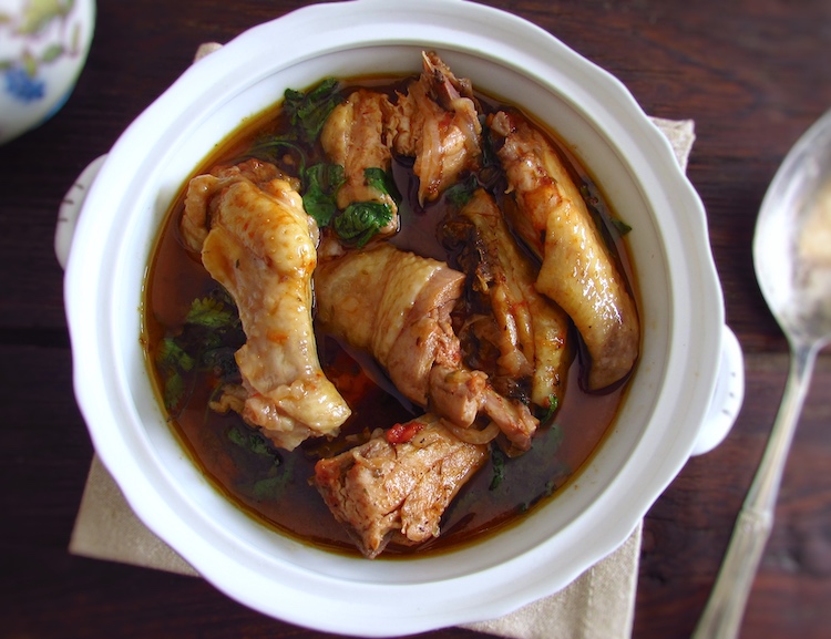 Stewed chicken with spices on a tureen