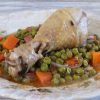 Chicken stew with peas and carrot on a plate