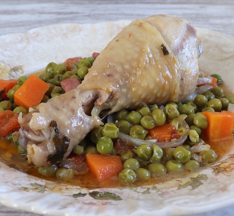 Chicken stew with peas and carrot on a plate