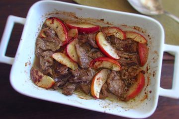 Easy baked steak with apple on a baking dish