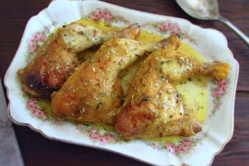 Chicken legs in the oven with mustard on a baking dish