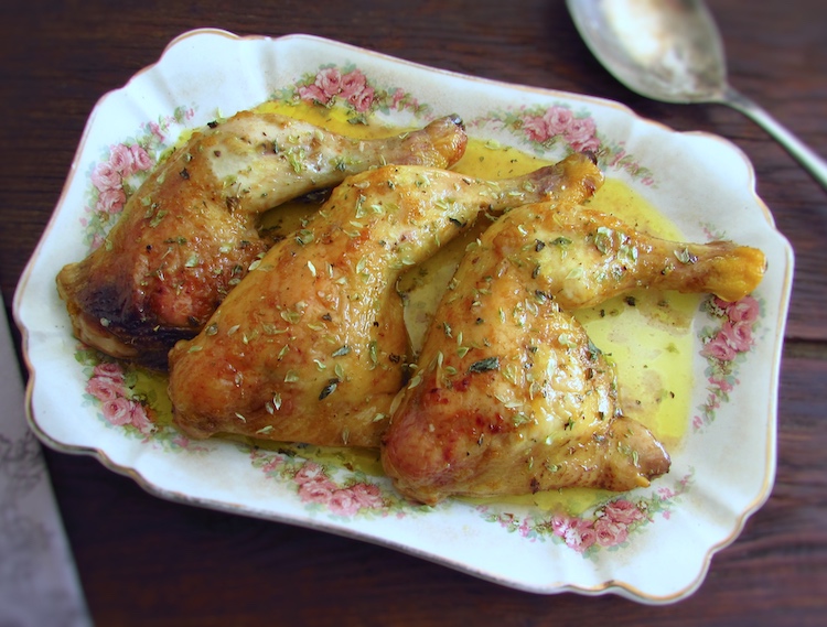 Chicken legs in the oven with mustard on a baking dish