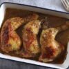 Tender and juicy baked chicken leg quarters in a baking dish