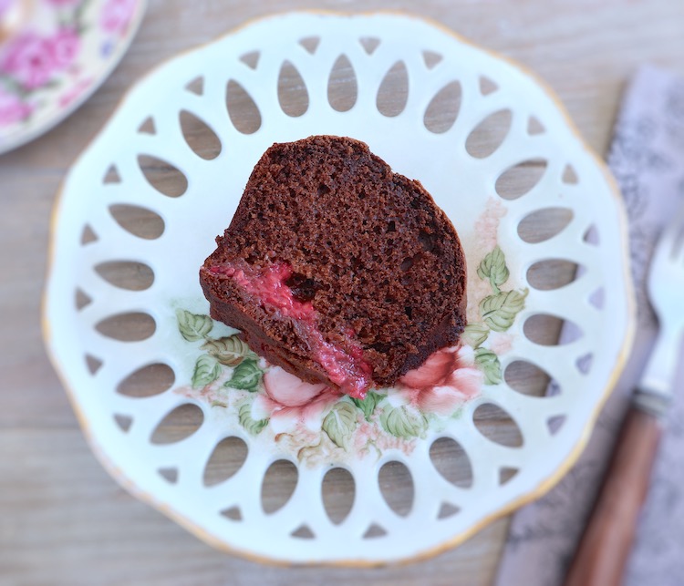 Chocolate and raspberry cake slice on a plate
