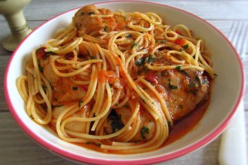 Stewed rabbit with spaghetti on a plate with a fork