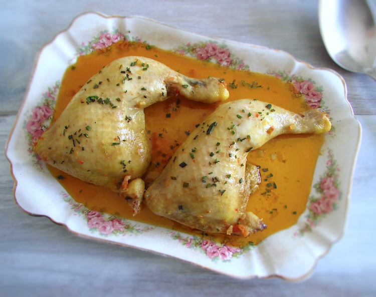 Stewed chicken legs with spices on a platter