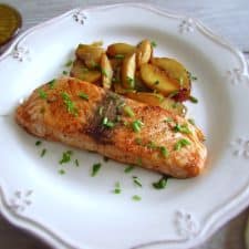 Salmon with caramelized apple on a plate with a fork
