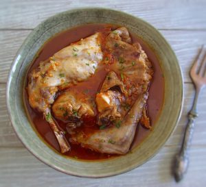 Rabbit stew with spices on a plate with a fork