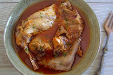 Stewed rabbit with spices on a plate with a fork