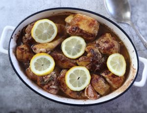 Easy baked chicken with cinnamon and lemon on a baking dish