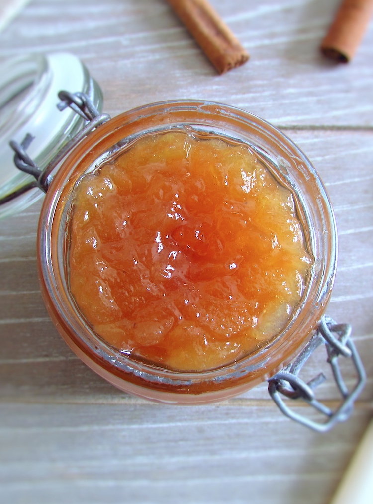 Pear honey jam in a glass jar with toasts and cinnamon stick