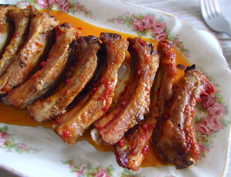 Delicious and easy roasted pork ribs on a platter with a fork