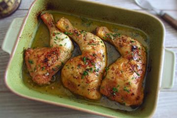 Roasted chicken legs on a baking dish