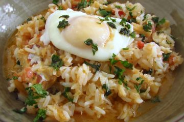 Cod rice with poached eggs on a dish bowl