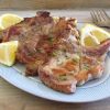 Grilled chops with lemon and rosemary on a platter