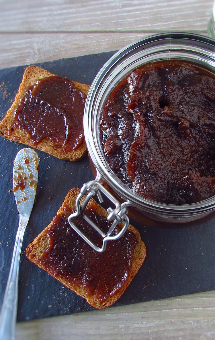 Quince and brown sugar jam on a glass jar with toasts
