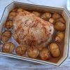 Baked turkey loin with potatoes on a baking dish