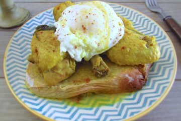 Stewed chicken with poached eggs on a plate