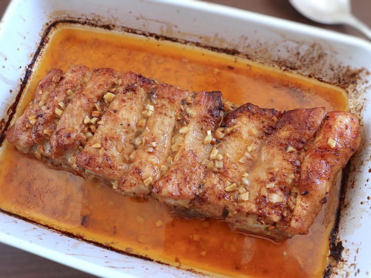 Roasted pork ribs with lemon and garlic on a baking dish