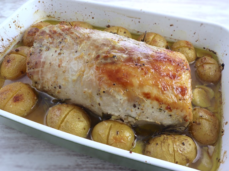Roasted pork loin with rosemary and honey on a baking dish