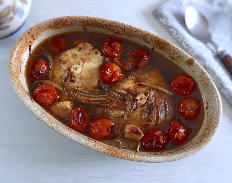 Baked dogfish with cherry tomato on a baking dish