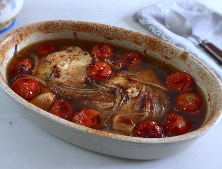 Baked dogfish with cherry tomato on a baking dish