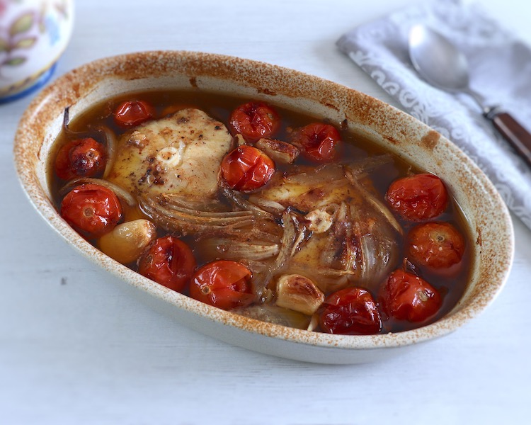 Baked dogfish with cherry tomato on a baking dish