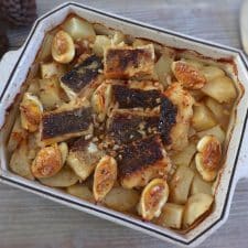 Baked cod with potatoes and egg on a baking dish