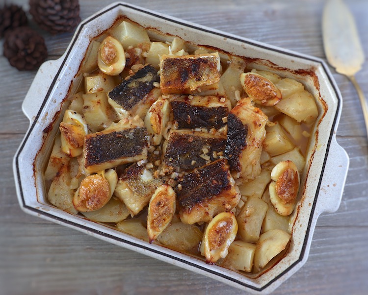 Baked cod with potatoes and egg on a baking dish