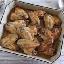 Chicken wings in the oven with olive oil and lemon on a baking dish