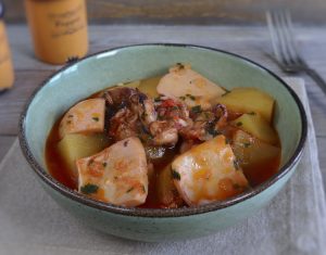 Cuttlefish stew with potatoes on a dish bowl
