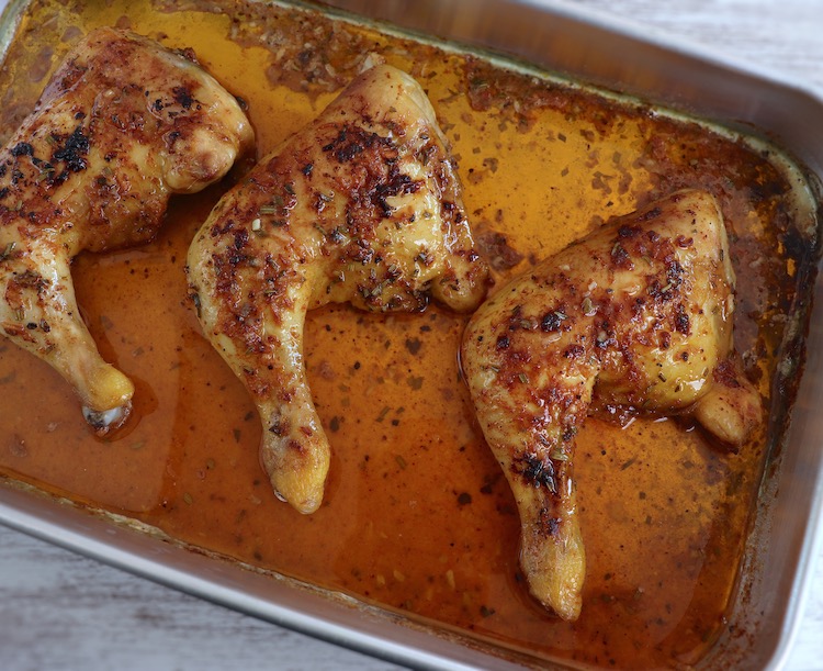 Spicy roasted chicken legs on a baking sheet