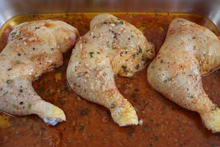 Spiced chicken legs on a baking sheet