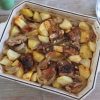 Baked pork ribs with potatoes on a baking dish