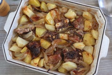 Baked pork ribs with potatoes on a baking dish