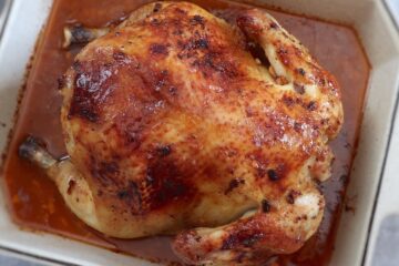 Honey lemon roast chicken in a baking dish