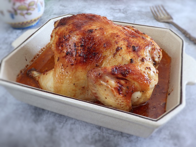 Roasted chicken with lemon and honey on a baking dish
