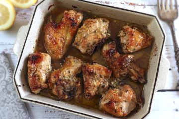 Baked chicken with lemon, honey and rosemary on a baking dish