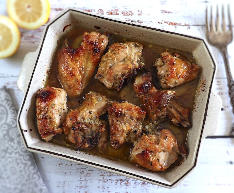 Baked chicken with lemon, honey and rosemary on a baking dish