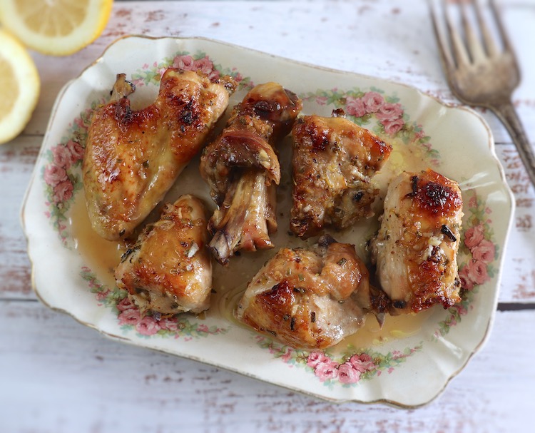 Baked chicken with lemon, honey and rosemary on a platter