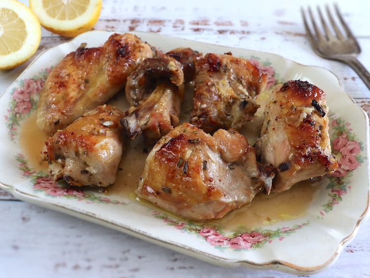 Baked chicken with lemon, honey and rosemary on a platter
